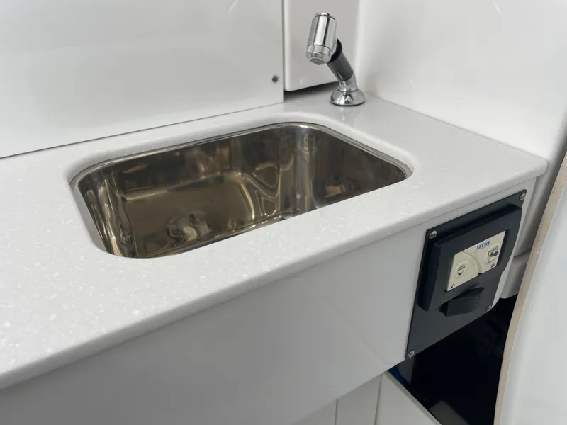 Slide: The Image of 2024 Blackfin 332cc boat sink and faucet in white countertop. - 47