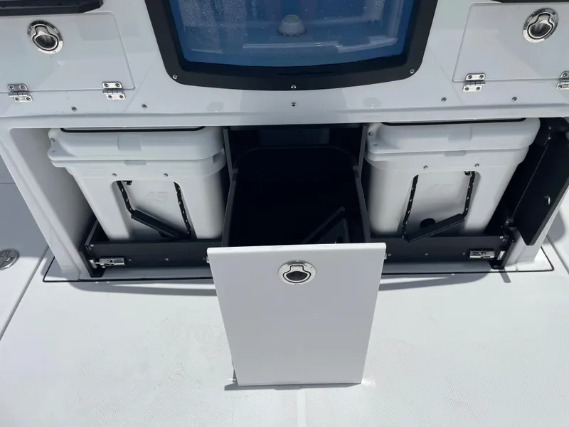 Slide: The Image of 2024 Blackfin 332cc storage compartments with coolers and center console. - 8
