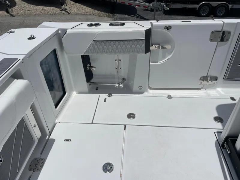 Slide: The Image of 2024 Blackfin 332cc boat deck with storage compartments and cup holders. - 9