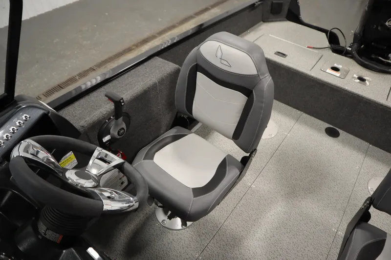 Slide: The Image of 2024 Lowe Fishing Machine 1675WT in a garage, showcasing interior and motor. - 11