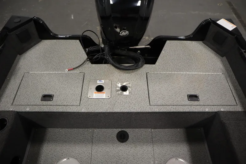 Slide: The Image of 2024 Lowe Fishing Machine 1675WT storage compartment with textured gray surface. - 15