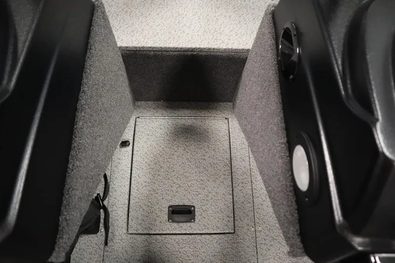 Slide: The Image of 2024 Lowe Fishing Machine 1675WT interior with carpeted flooring and storage compartment. - 24