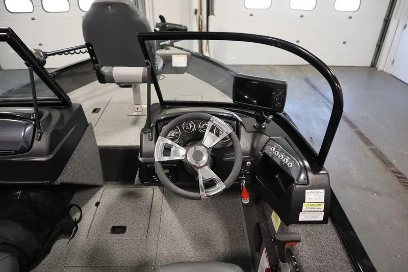 Slide: The Image of 2024 Lowe Fishing Machine 1675WT interior with steering wheel and control panel. - 29
