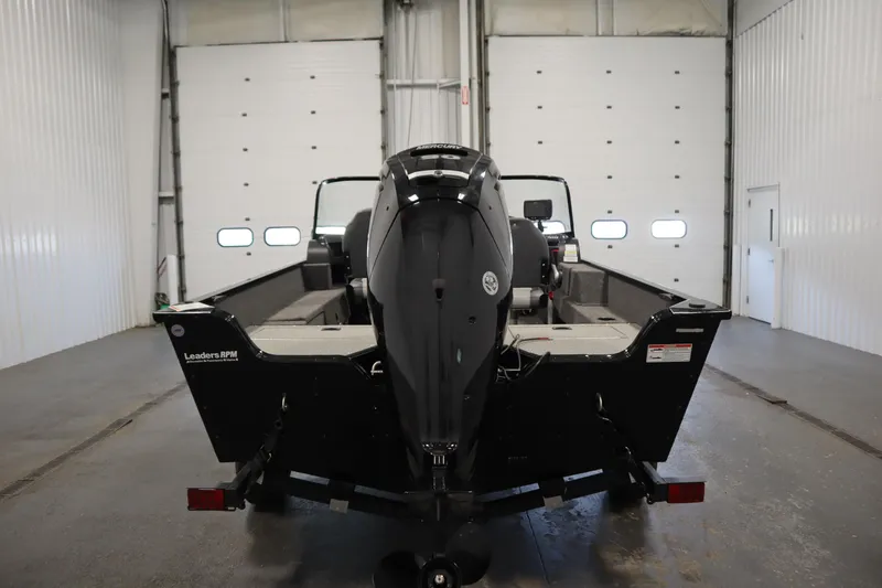 Slide: The Image of 2024 Lowe Fishing Machine 1675WT boat in showroom, featuring sleek design and modern equipment. - 3