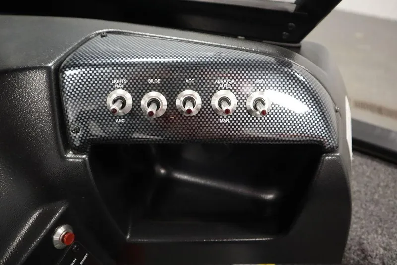 Slide: The Image of Control panel of 2024 Lowe Fishing Machine 1675WT with switches for lights, bilge, and accessories. - 31