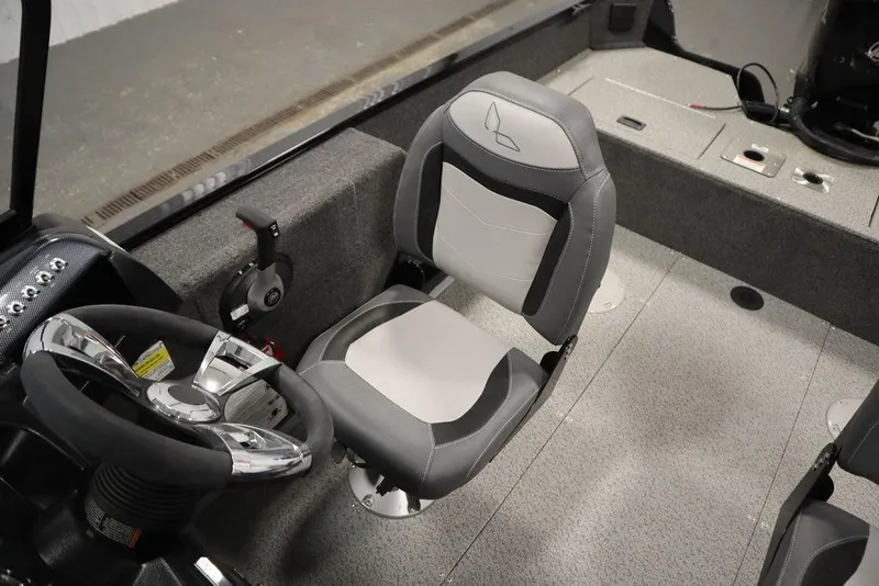 Slide: The Image of 2024 Lowe Fishing Machine 1675WT interior with steering wheel and seating. - 33