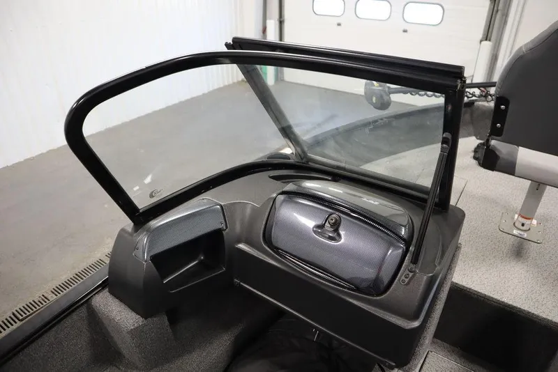 Slide: The Image of 2024 Lowe Fishing Machine 1675WT interior with windshield and storage compartment. - 34
