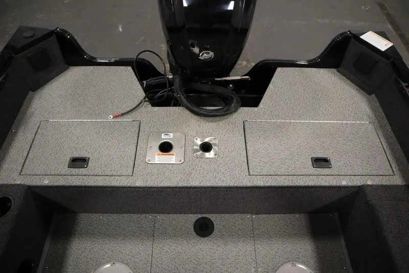 Slide: The Image of 2024 Lowe Fishing Machine 1675WT boat interior with storage compartments and motor mount. - 40