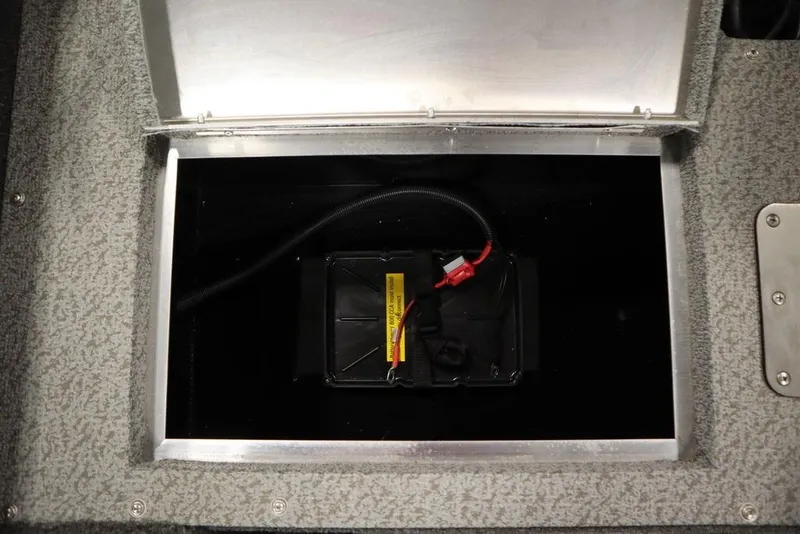 Slide: The Image of 2024 Lowe Fishing Machine 1675WT battery compartment with secure wiring. - 41