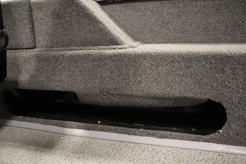 Slide: The Image of 2024 Lowe Fishing Machine 1675WT interior detail with gray carpeted surface. - 42