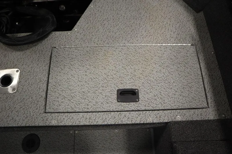 Slide: The Image of 2024 Lowe Fishing Machine 1675WT boat storage compartment with textured surface and handle. - 46