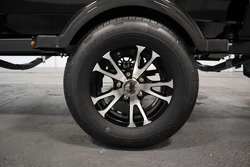 Slide: The Image of 2024 Lowe Fishing Machine 1675WT trailer wheel, black and silver alloy design. - 48