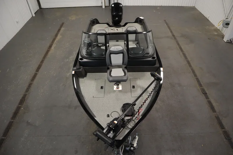 Slide: The Image of 2024 Lowe Fishing Machine 1675WT boat with Mercury engine in a garage setting. - 5