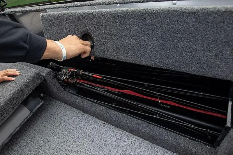 Slide: The Image of 2024 Lowe Fishing Machine 1675WT rod storage compartment with fishing rods inside. - 53