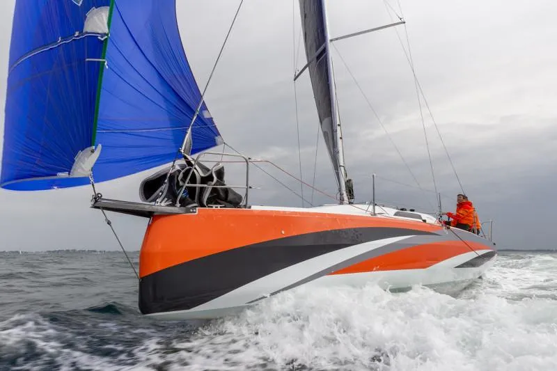 Slide: The Image of 2024 Jeanneau Sun Fast 3300 sailing with blue spinnaker and orange hull. - 26