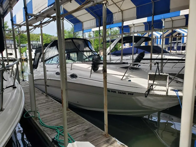 The Image of 2006 Sea Ray 280 Sundancer docked under a blue and white canopy. - 0