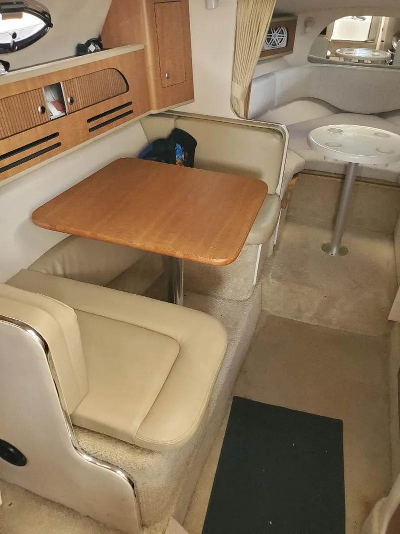 Slide: The Image of 2006 Sea Ray 280 Sundancer cabin interior with dining area and seating. - 12
