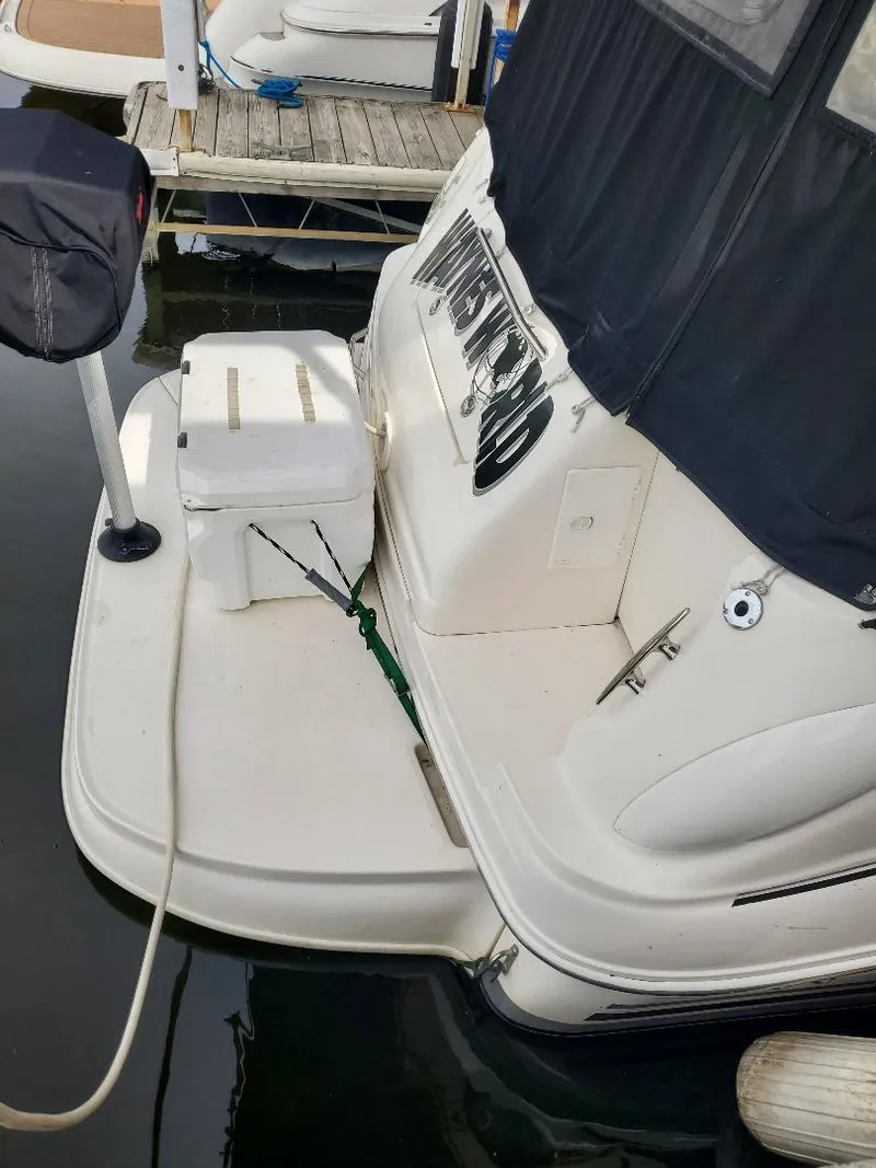 Slide: The Image of 2006 Sea Ray 280 Sundancer boat docked with covered seating area. - 15