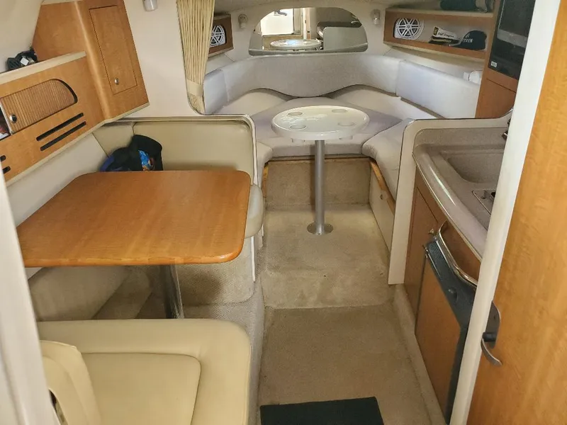 Slide: The Image of Interior of 2006 Sea Ray 280 Sundancer with seating, table, and kitchenette. - 4