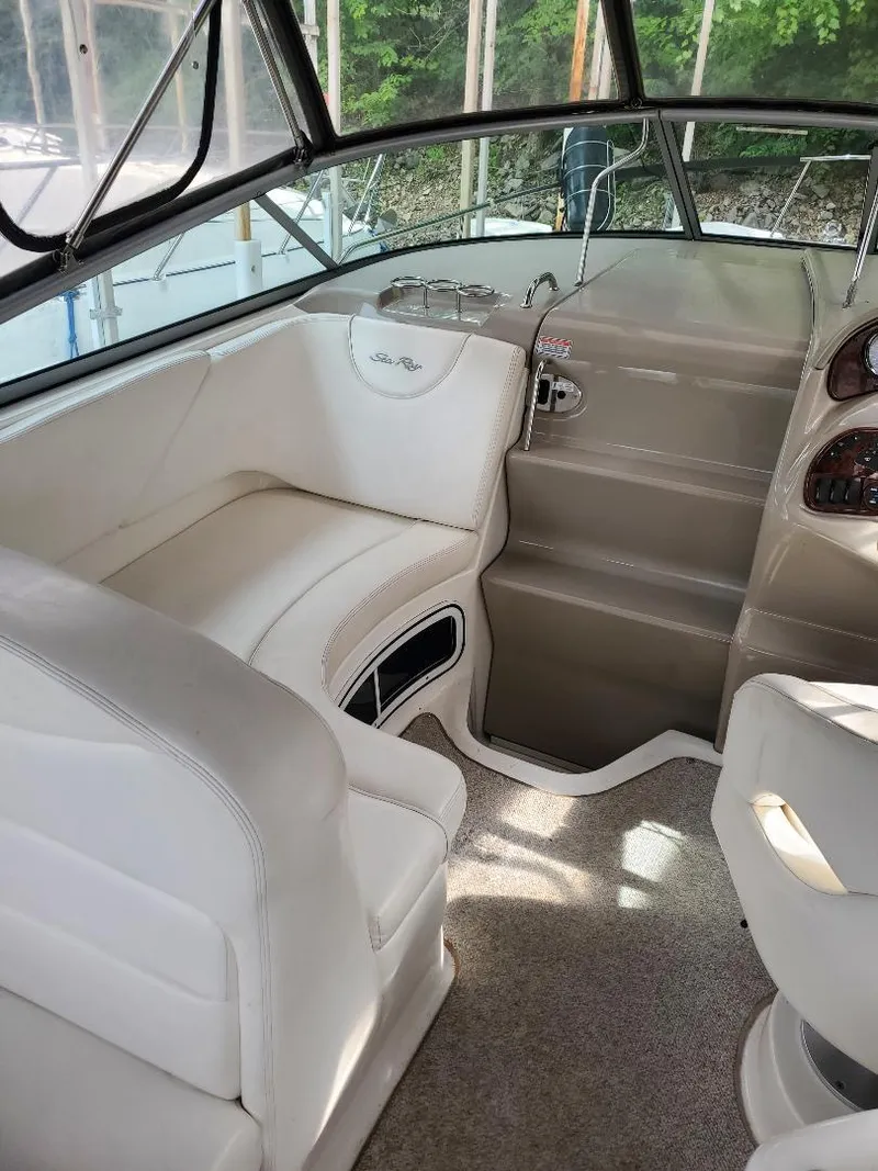 Slide: The Image of 2006 Sea Ray 280 Sundancer interior with white seating and helm, showcasing luxury design. - 6