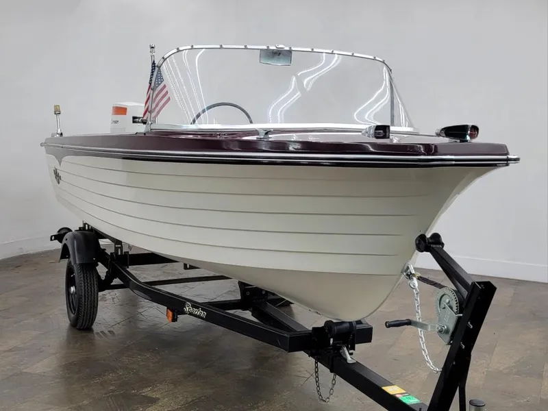 Slide: The Image of 1969 Crestliner Marauder boat on trailer, white hull, maroon trim, American flag. - 13