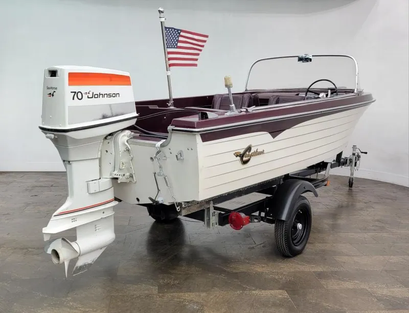 Slide: The Image of 1969 Crestliner Marauder boat with Johnson 70 HP outboard motor and American flag. - 17