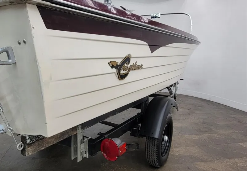 Slide: The Image of 1969 Crestliner Marauder boat on trailer, white and maroon color scheme. - 18