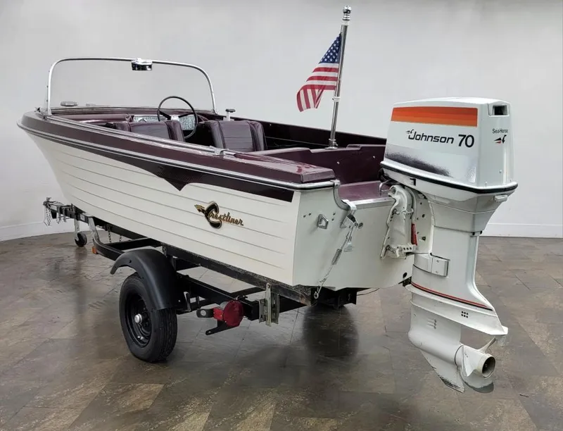 Slide: The Image of 1969 Crestliner Marauder boat with Johnson 70 outboard motor on trailer. - 21