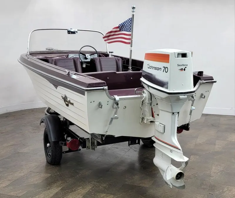 Slide: The Image of 1969 Crestliner Marauder boat with Johnson 70 outboard motor and American flag. - 22