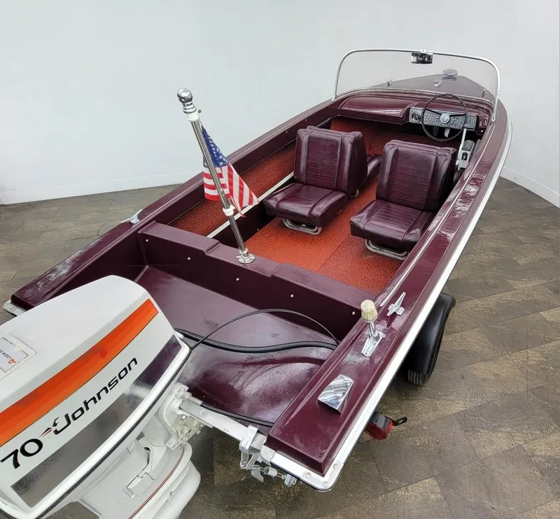 Slide: The Image of 1969 Crestliner Marauder boat with Johnson 70 outboard motor and American flag. - 25