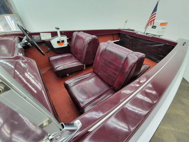 Slide: The Image of 1969 Crestliner Marauder boat interior with maroon seats and red carpet. - 28