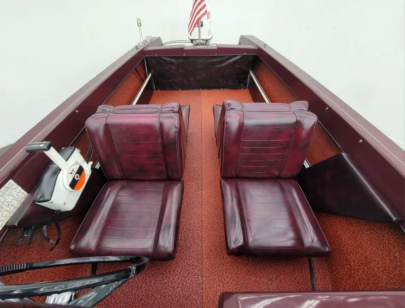Slide: The Image of 1969 Crestliner Marauder boat interior with red leather seats and American flag. - 29