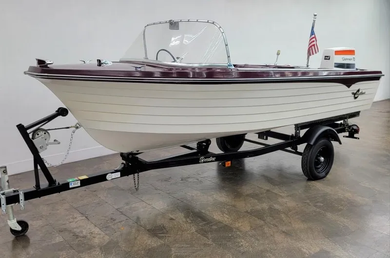 Slide: The Image of 1969 Crestliner Marauder boat on trailer with American flag and vintage outboard motor. - 3