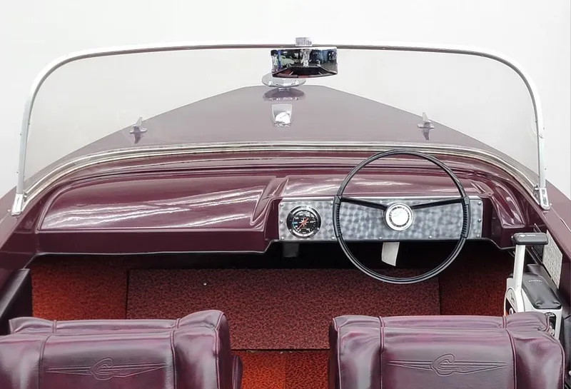Slide: The Image of 1969 Crestliner Marauder boat dashboard with steering wheel and maroon seats. - 30