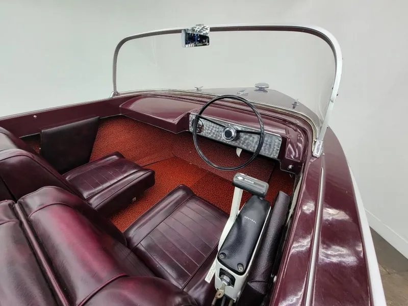 Slide: The Image of 1969 Crestliner Marauder boat interior with maroon seats and vintage steering wheel. - 32