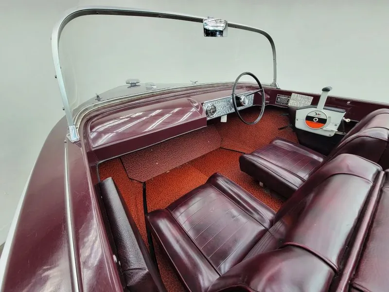 Slide: The Image of 1969 Crestliner Marauder boat interior with maroon seats and dashboard. - 33