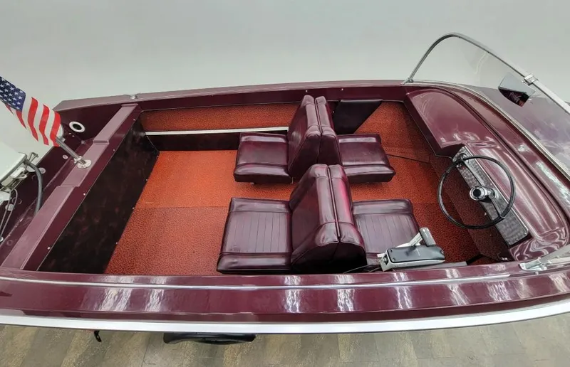 Slide: The Image of 1969 Crestliner Marauder boat with maroon interior and American flag. - 34