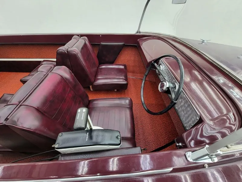 Slide: The Image of 1969 Crestliner Marauder boat interior with red seats and steering wheel. - 35