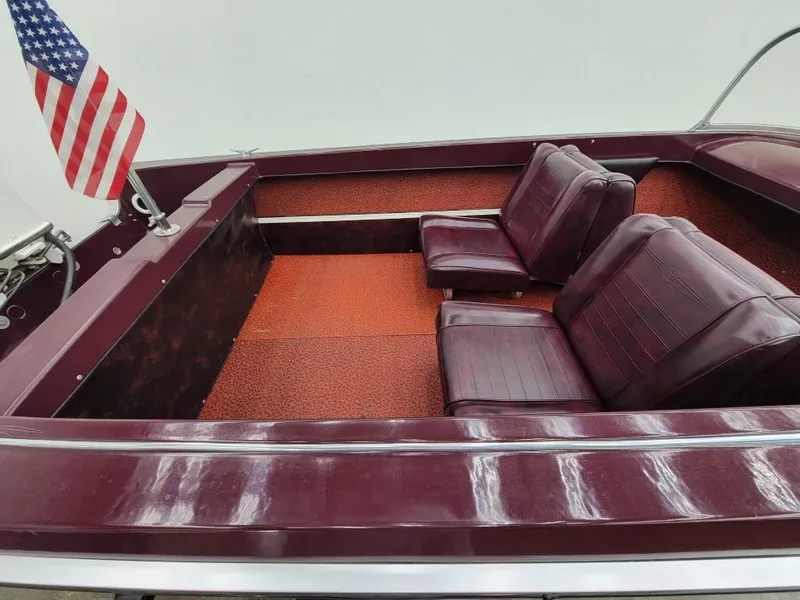 Slide: The Image of 1969 Crestliner Marauder boat interior with red seats and American flag. - 36
