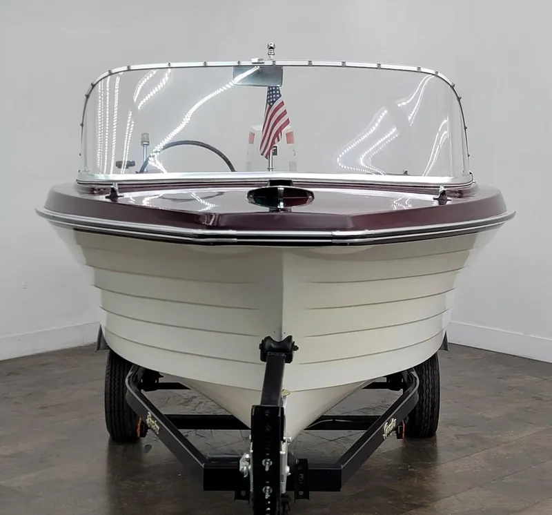 Slide: The Image of 1969 Crestliner Marauder boat on trailer, front view with American flag. - 6
