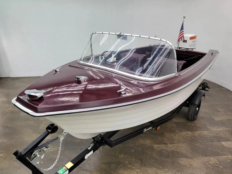 Slide: The Image of 1969 Crestliner Marauder boat with maroon and white finish on a trailer. - 7