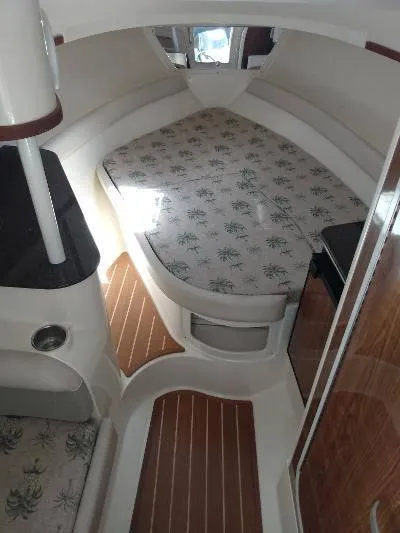 Slide: The Image of Interior cabin of 2014 Scout 262 Abaco boat with bed and wooden flooring. - 10