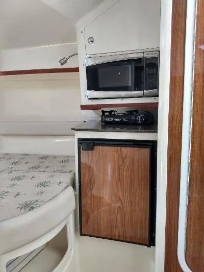 Slide: The Image of 2014 Scout 262 Abaco cabin with microwave, mini-fridge, and bed. - 11