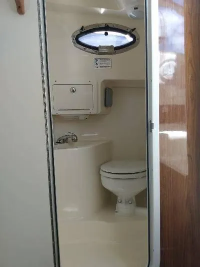 Slide: The Image of 2014 Scout 262 Abaco boat interior bathroom with toilet and sink - 12