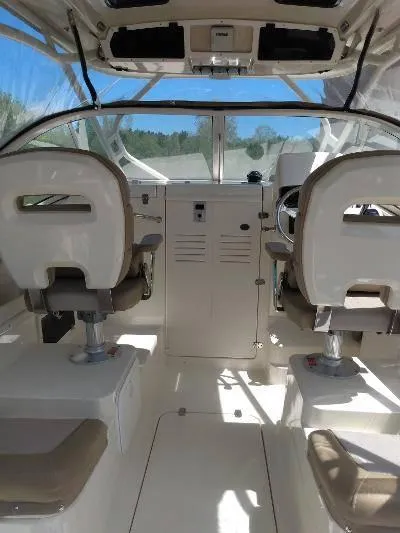 Slide: The Image of Interior of 2014 Scout 262 Abaco boat with dual captain chairs and control panel. - 7