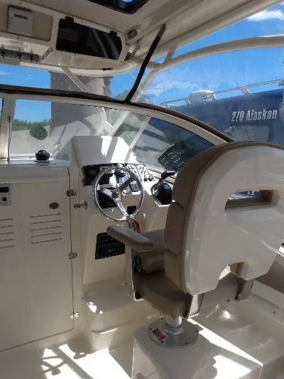 Slide: The Image of Interior cockpit of 2014 Scout 262 Abaco boat with steering wheel and captain's chair. - 8