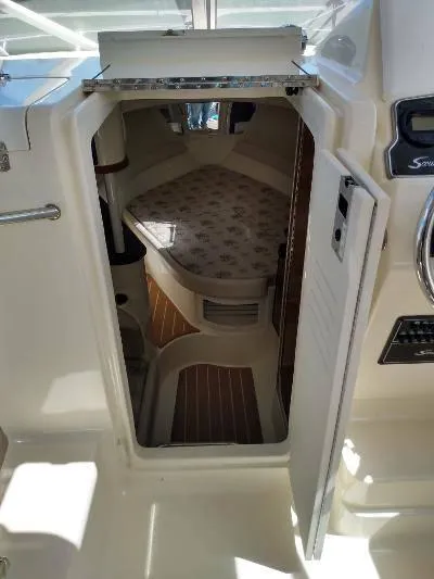 Slide: The Image of 2014 Scout 262 Abaco cabin interior with bed and wooden flooring. - 9