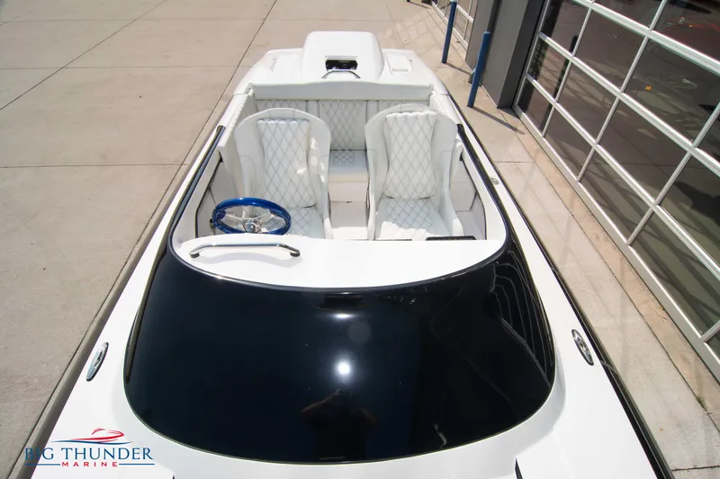 Slide: The Image of 2019 Spectre Screaming Eagle 22 Talon boat with white interior and blue steering wheel. - 18