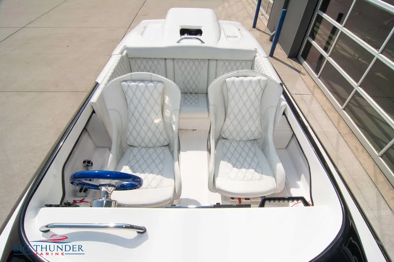 Slide: The Image of 2019 Spectre Screaming Eagle 22 Talon boat with white interior and blue steering wheel. - 19