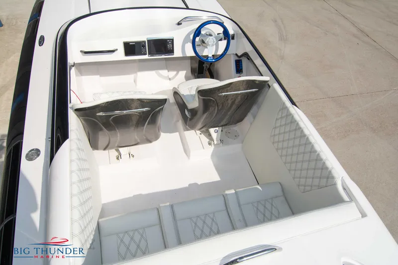 Slide: The Image of 2019 Spectre Screaming Eagle 22 Talon boat interior with white seating and blue steering wheel. - 20
